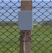 The analyzer is available in a NEMA-4 standard environmental housing for attachment directly to a fence post. fence perimeter detection security system equipment nema-4 nema 4 box